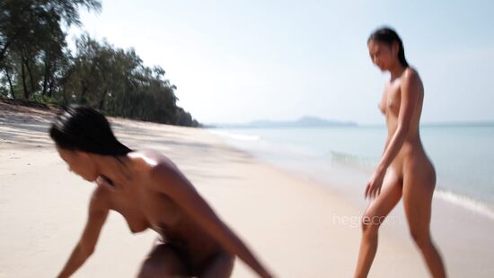 Asian lesbians in seductive beach scene