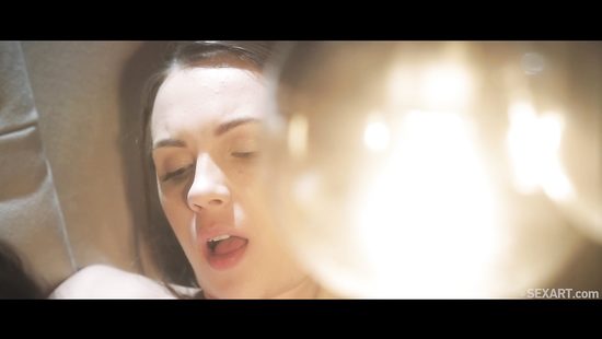 Sultry lesbians doing it affectionately on a sofa