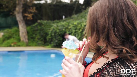 Redhead throats cock by the pool